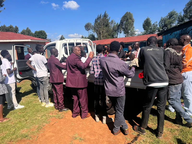 People gathered around a truck loaded with supplies