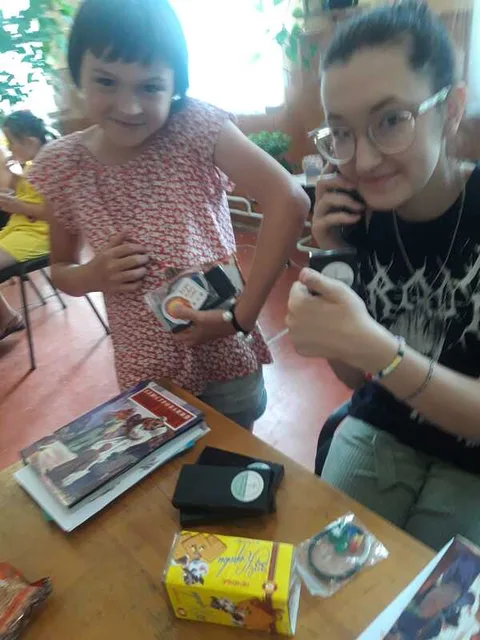Child and adult making crafts at a table
