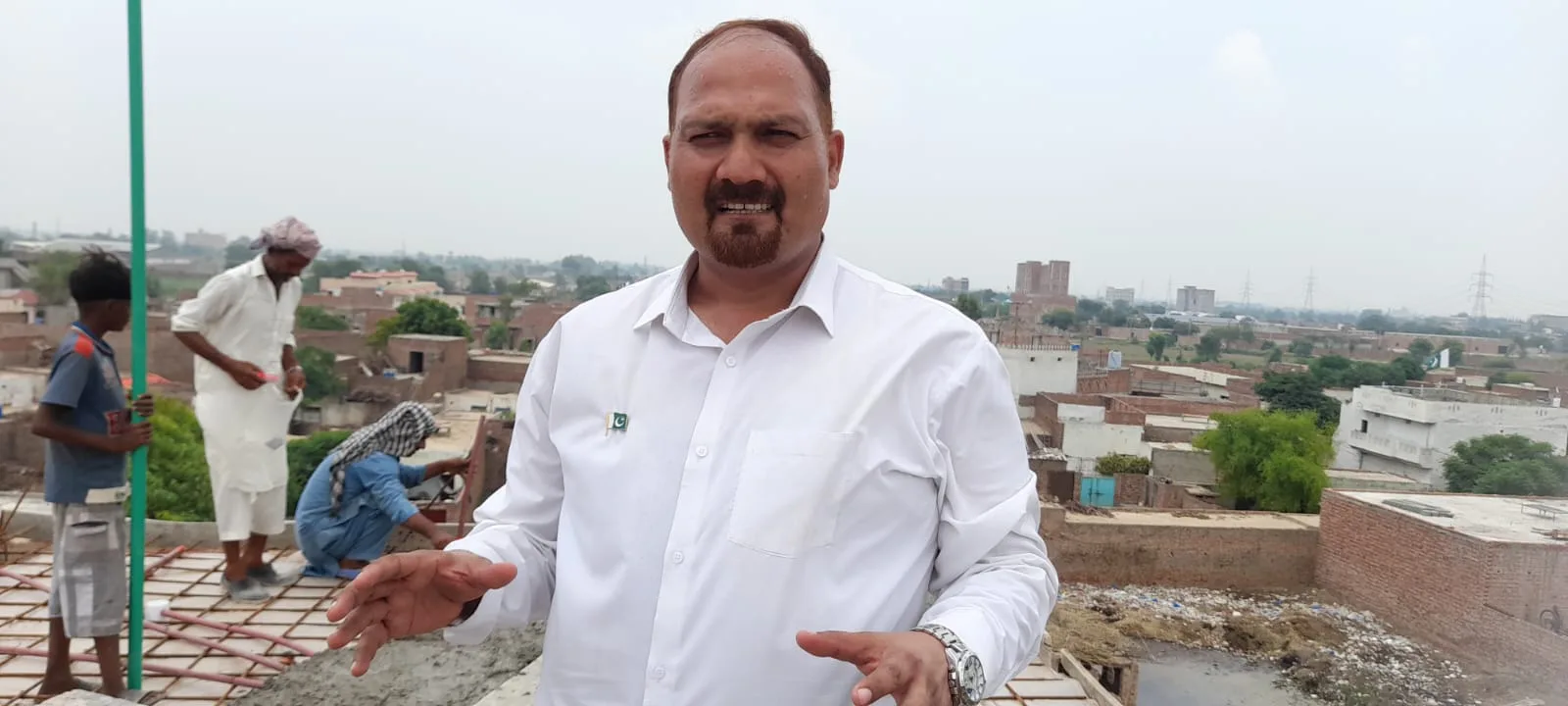 Man speaking at the Pakistan Bible College construction site