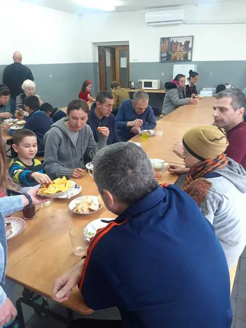 People sharing a meal at a long table