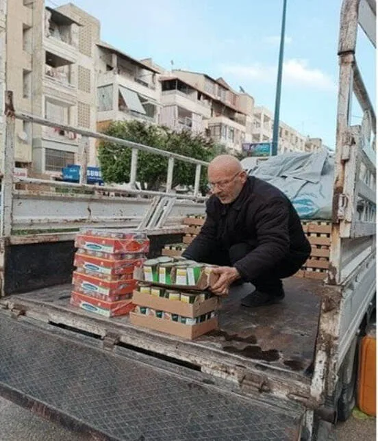 A man unloading boxes from a truck
