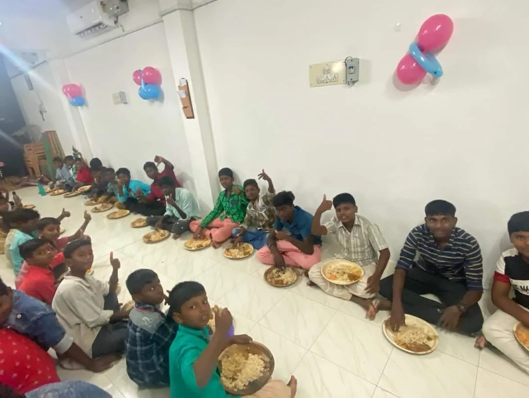 Children and adults sharing a meal in a decorated room