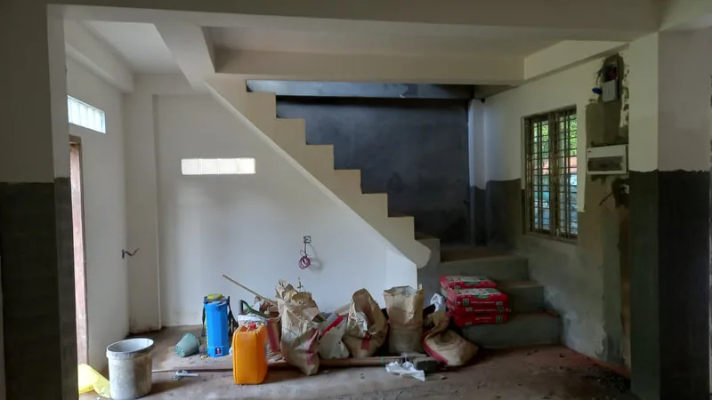 Supplies beneath a newly painted staircase