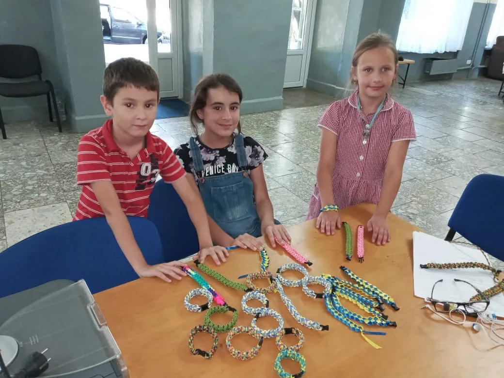 Children making crafts at a table