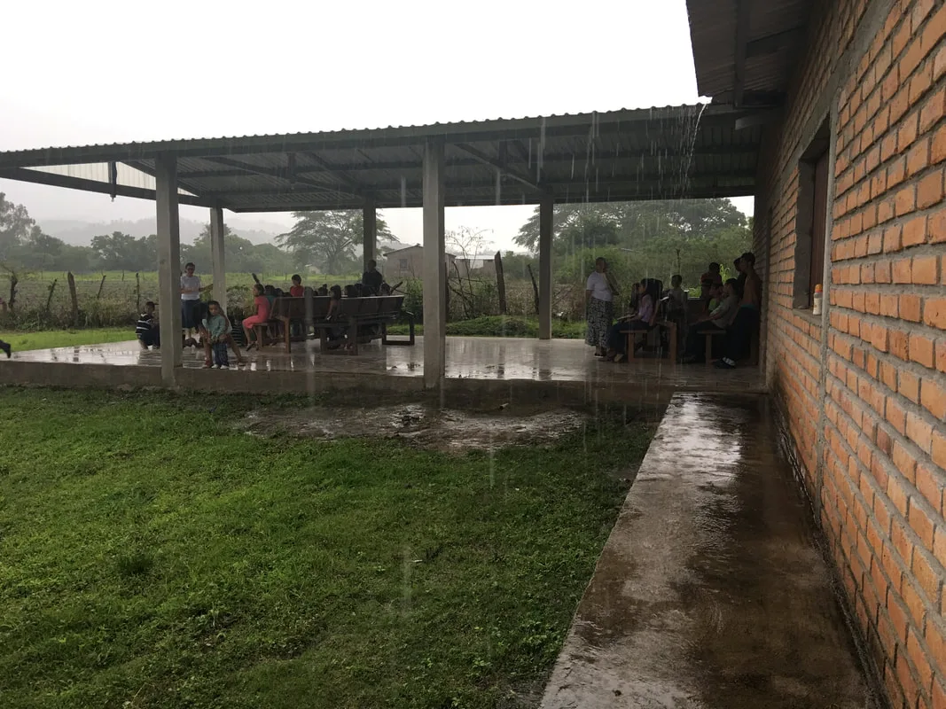 Covered outdoor pavilion beside a brick building