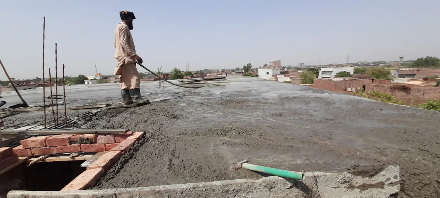 Worker standing on a newly concreted roof