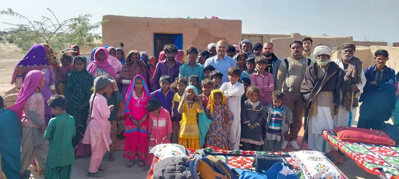 Group of adults and children gathered in a courtyard