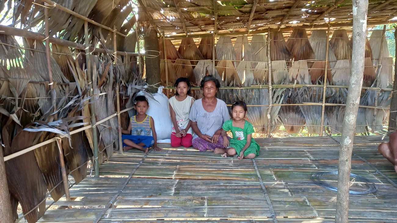 Woman and children inside a wooden house