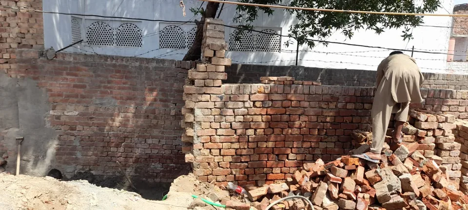Worker arranging bricks on a wall