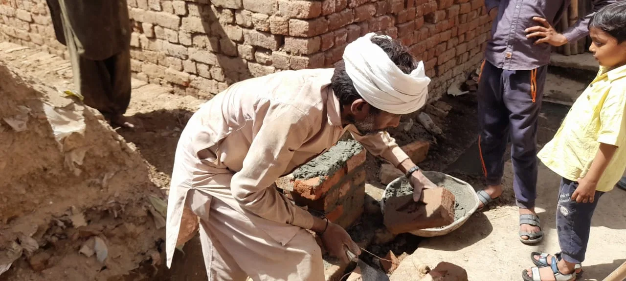 People clearing bricks at a construction site