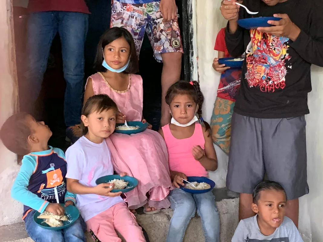Children holding bowls of food