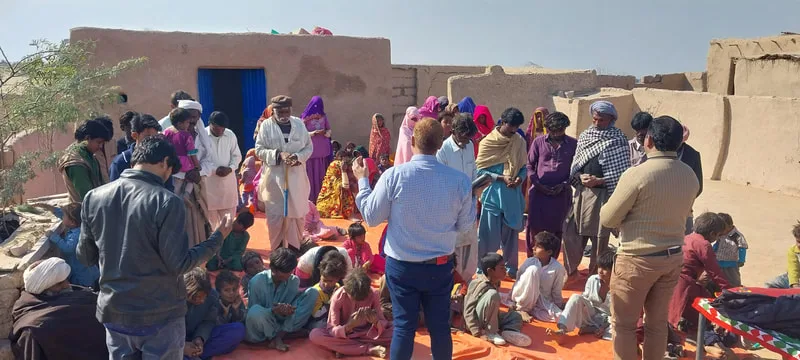 Adults and children gathered in a courtyard
