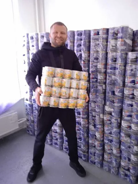 Man carrying a tray of canned food