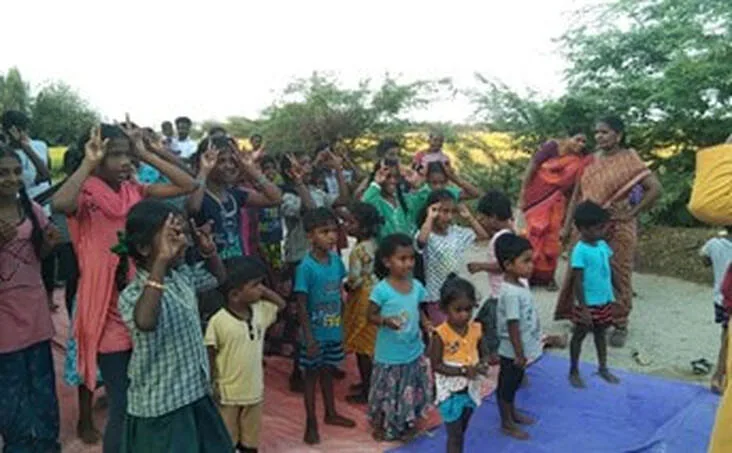 Group of adults and children gathered outdoors
