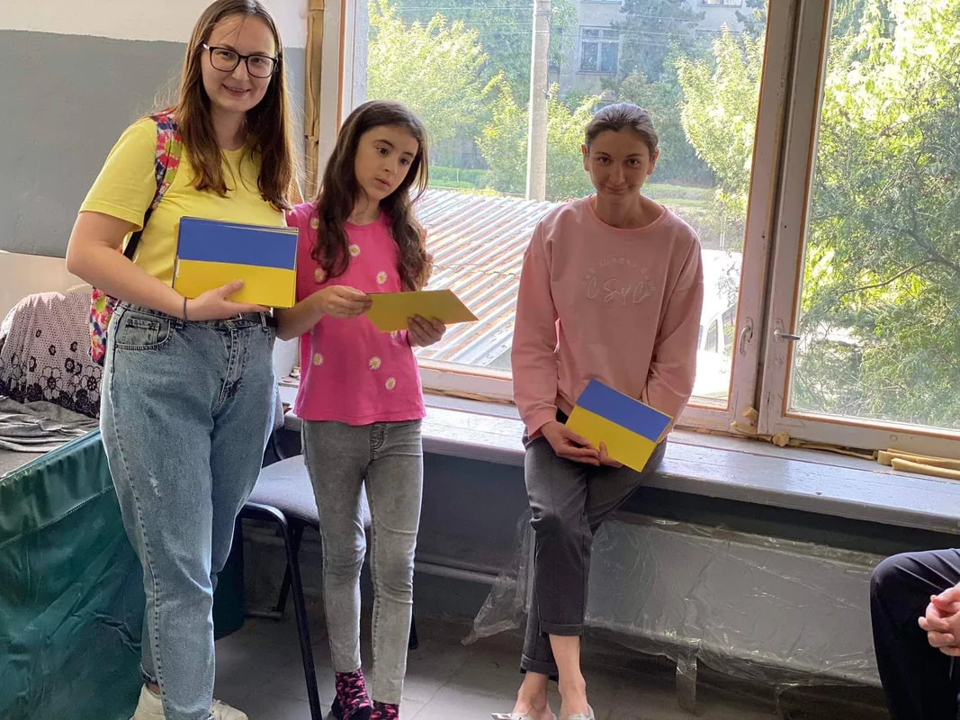 Three young people holding packages