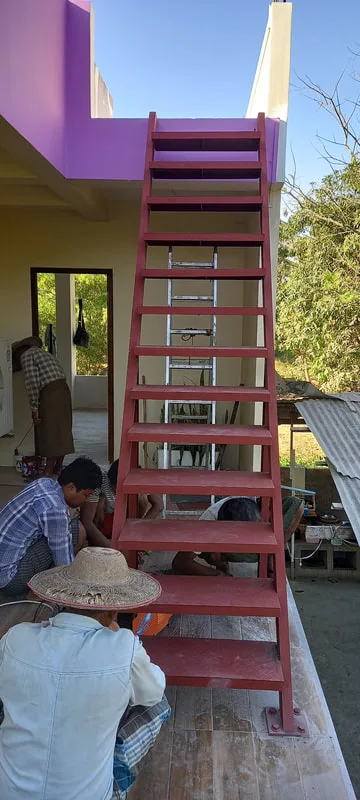 Workers fitting a metal staircase