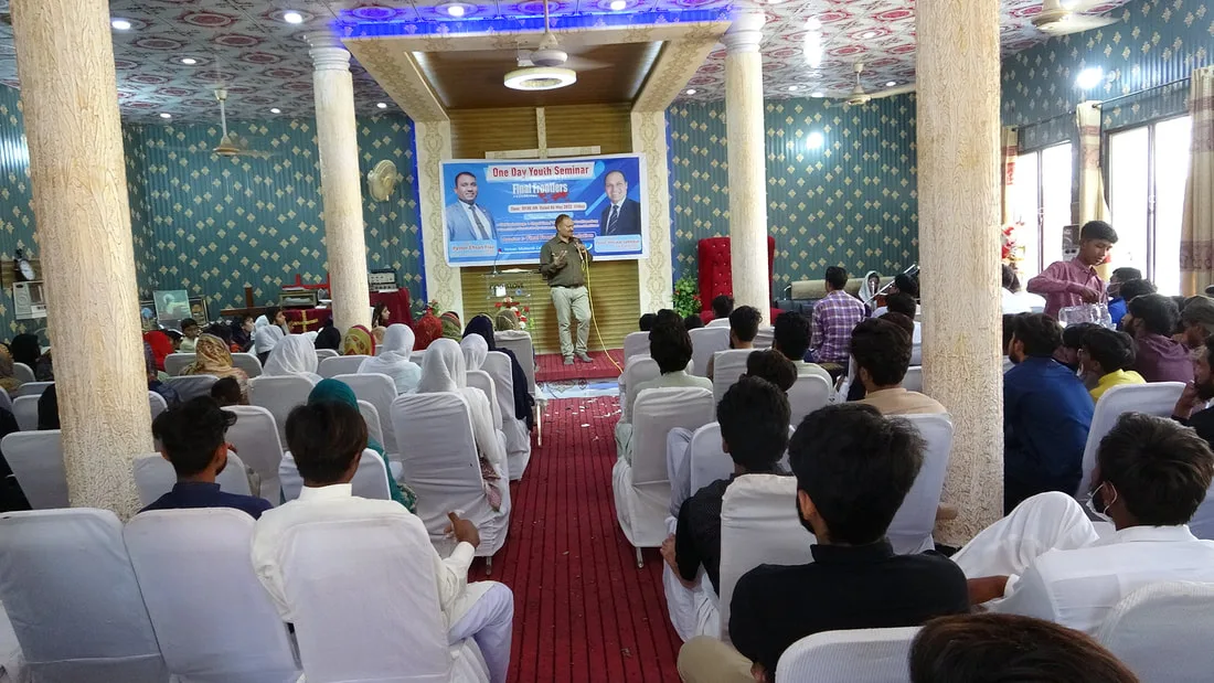 Speaker addressing a youth gathering indoors