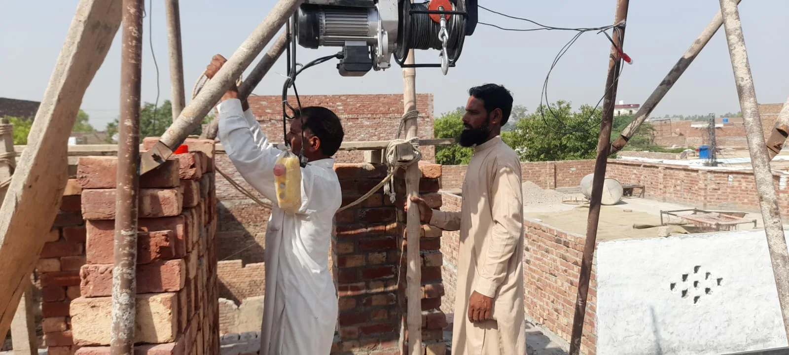 Workers operating a material lift