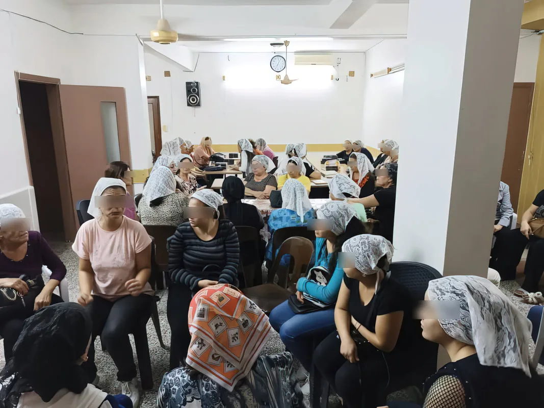 Women seated at an indoor gathering