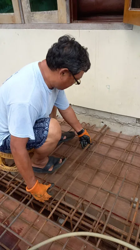 Worker fastening steel floor reinforcement