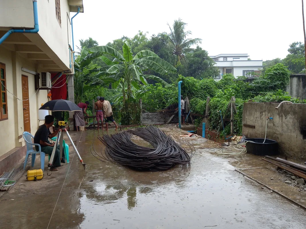 Coiled reinforcing rods beside a building