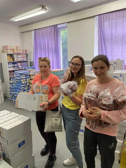 People holding packages inside a food storeroom