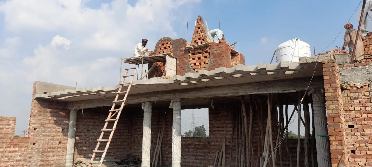 Decorative brickwork above an unfinished upper floor