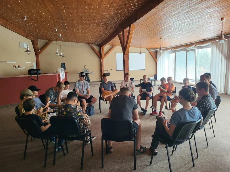 People seated in a circle in a meeting room