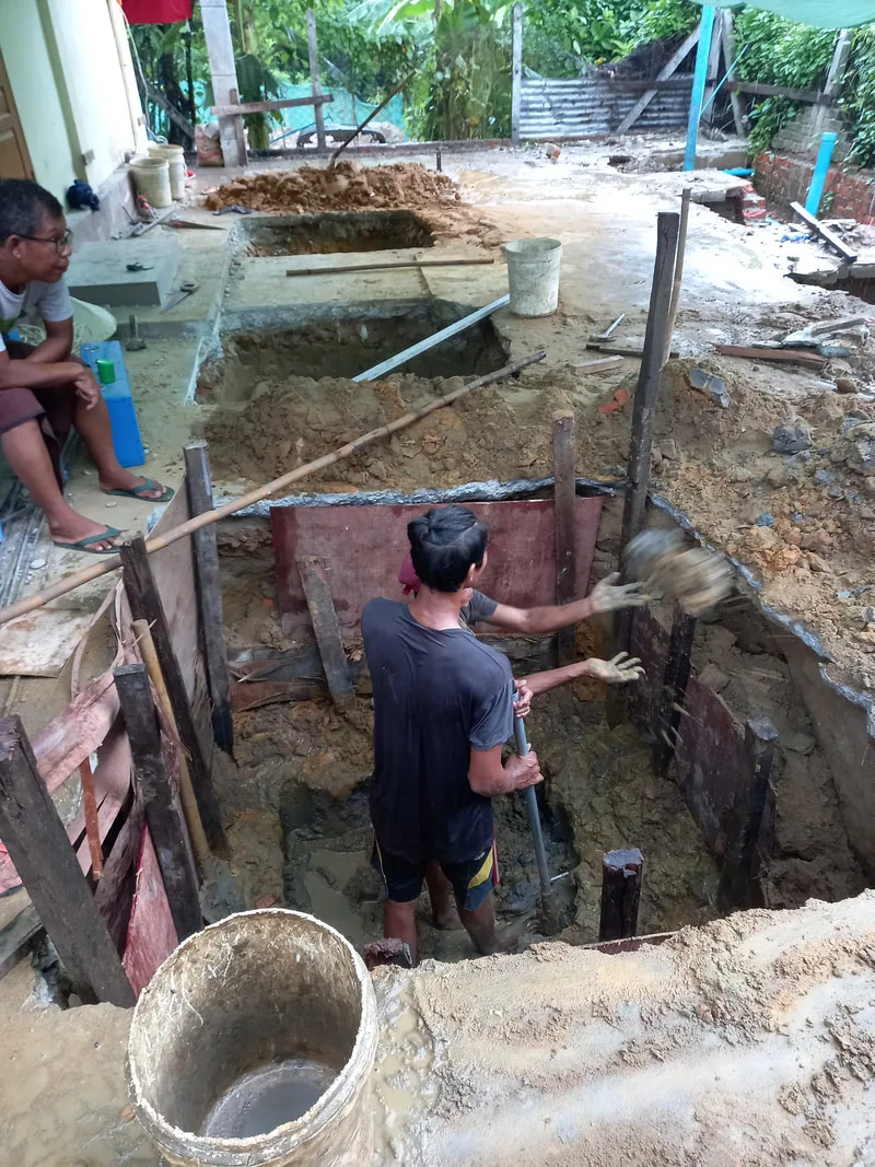 Worker standing in a foundation pit