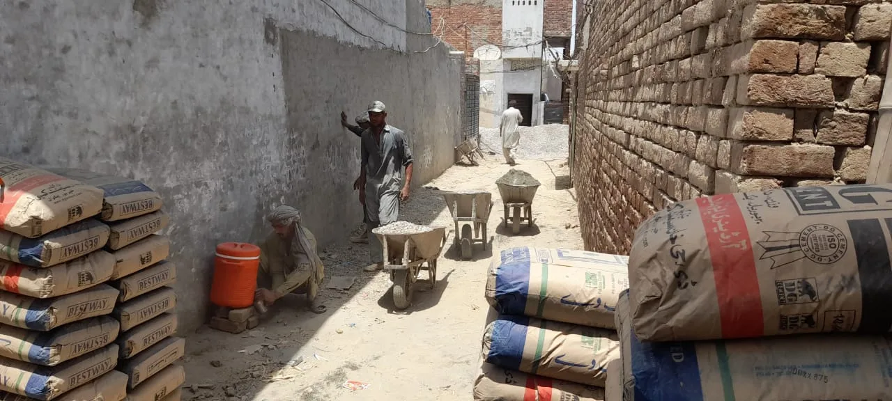 Cement bags stacked beside a passageway