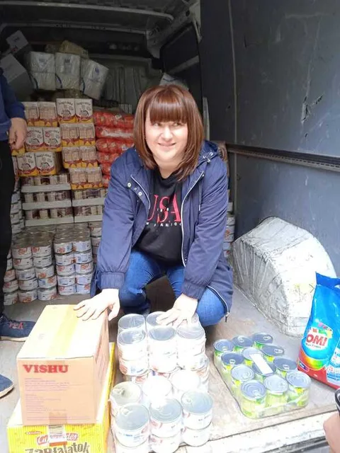 Woman beside humanitarian food supplies