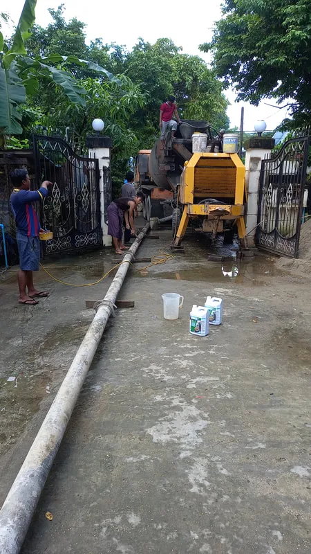Concrete pumping equipment beside a building