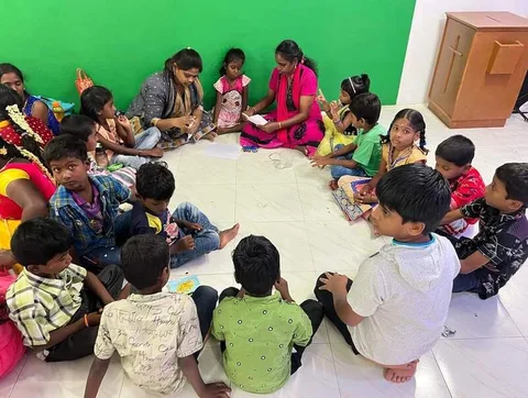 Children seated together with plates and books