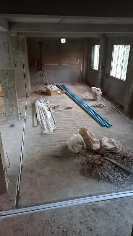 Unfinished room with electrical conduits and tools