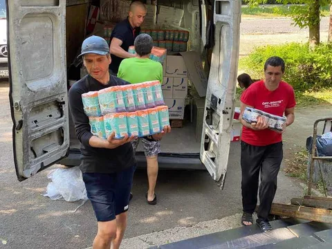 People unloading food packages from a van