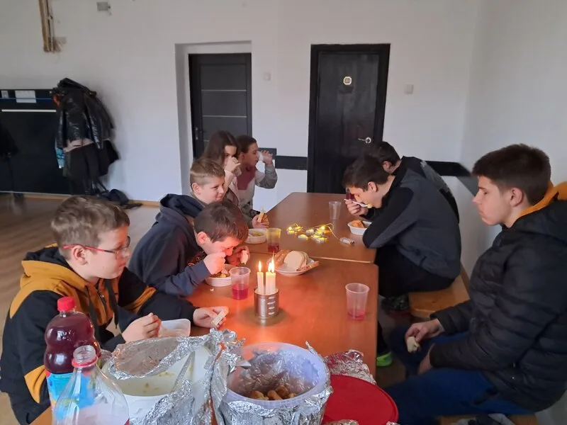 Children eating by candlelight