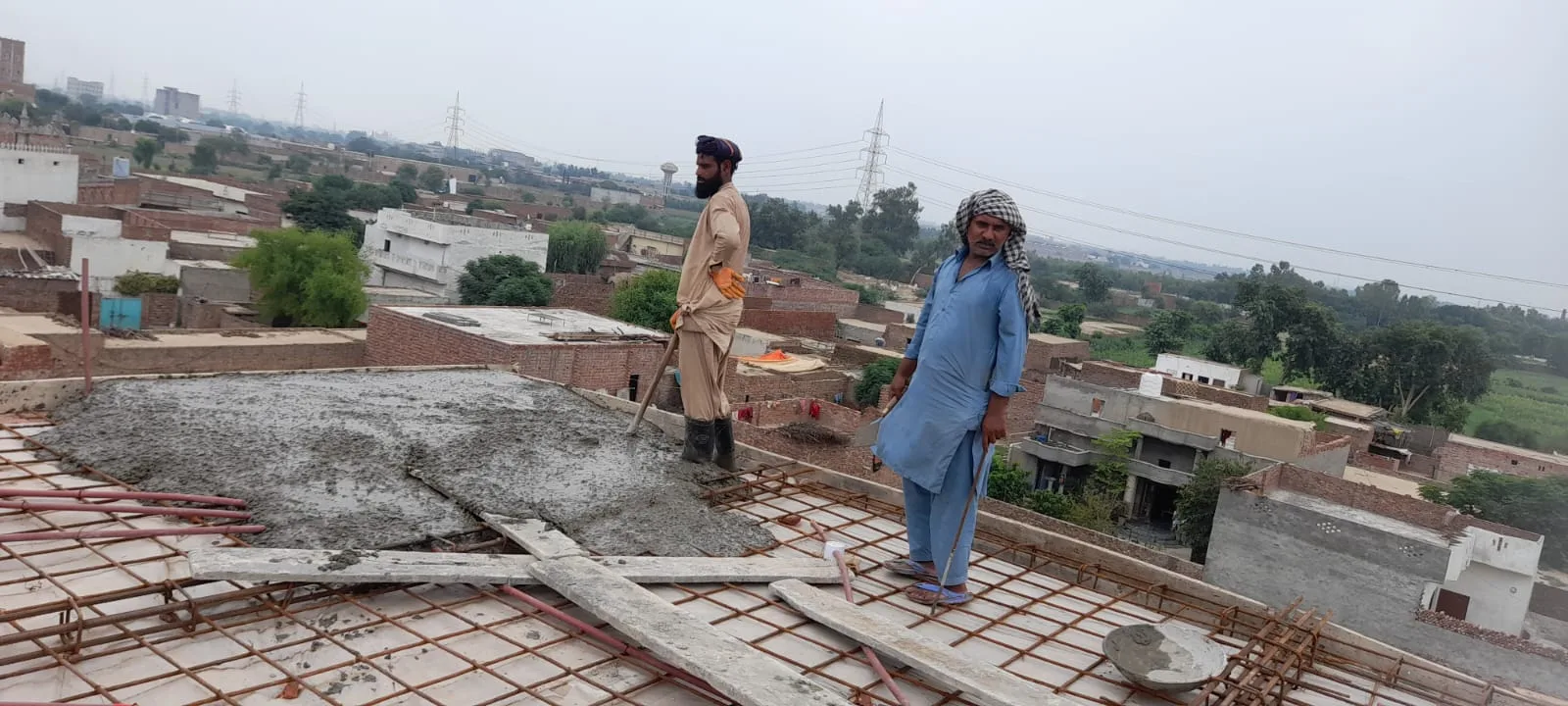 Workers beside a freshly poured roof slab
