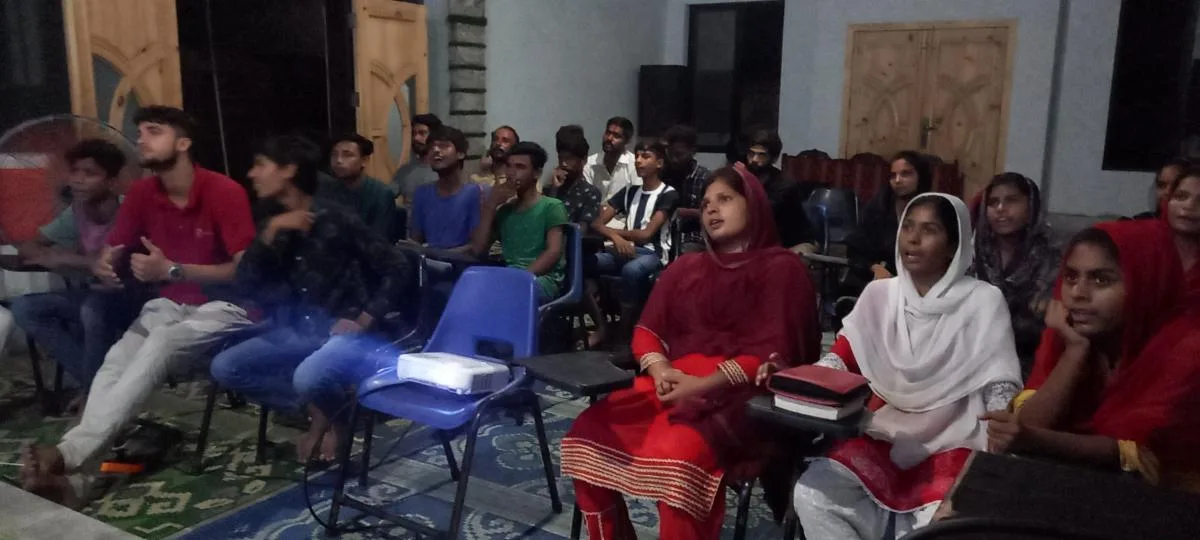 Young people seated in a meeting room