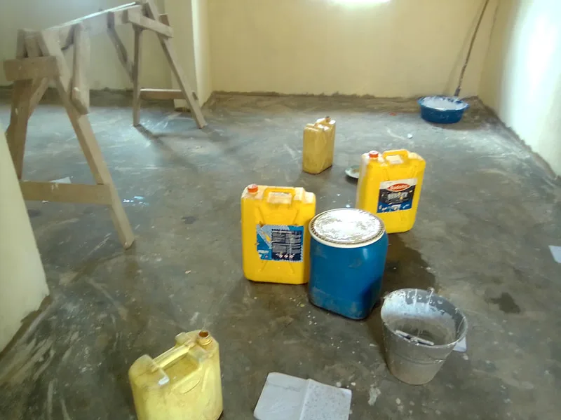 Supplies and buckets inside a newly plastered room