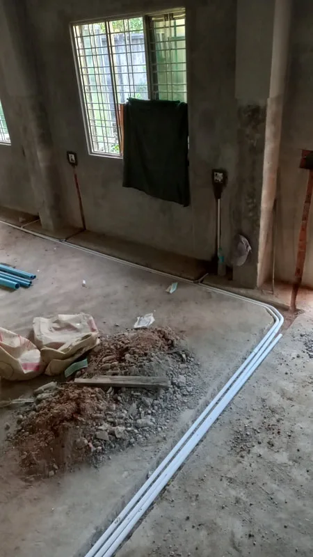 Electrical conduits running along an unfinished floor