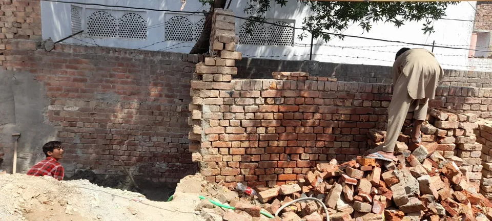 Worker building a low brick wall