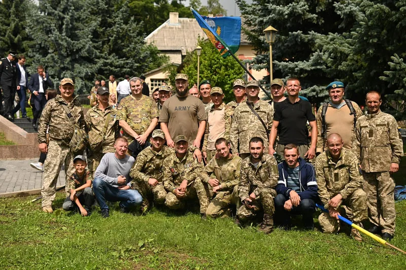 Group posing outdoors in military uniforms