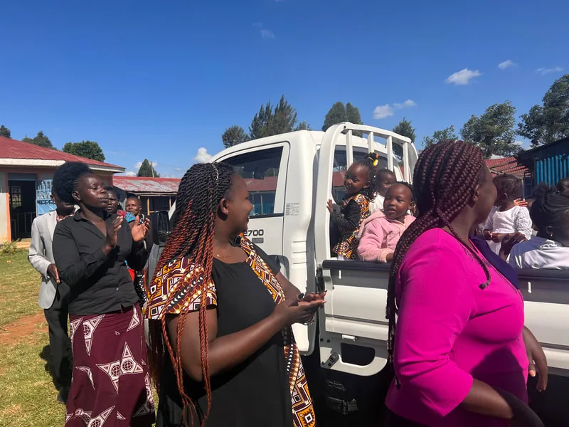 Women gathered beside a delivery truck