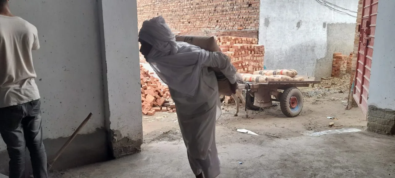 Worker plastering a doorway