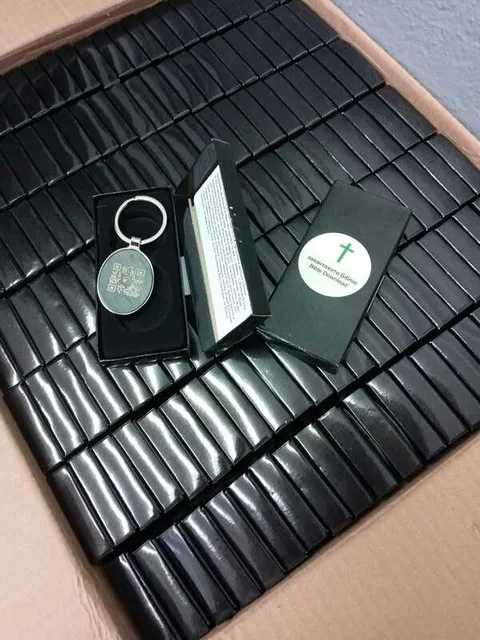 Bibles and key chains arranged on a dark surface