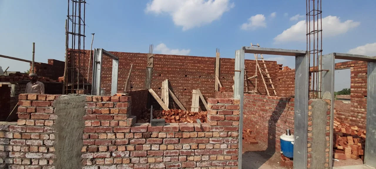 Brick walls and reinforced columns under construction