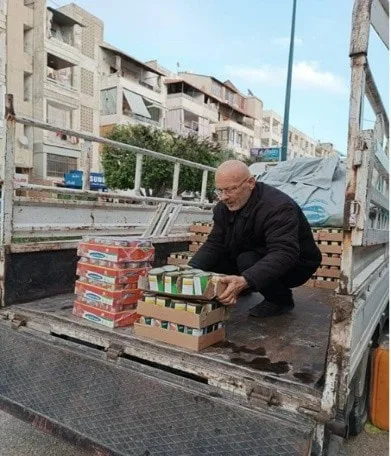 Man unloading food packages from a truck