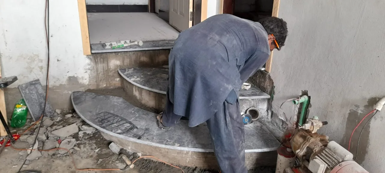 Worker finishing curved stone steps