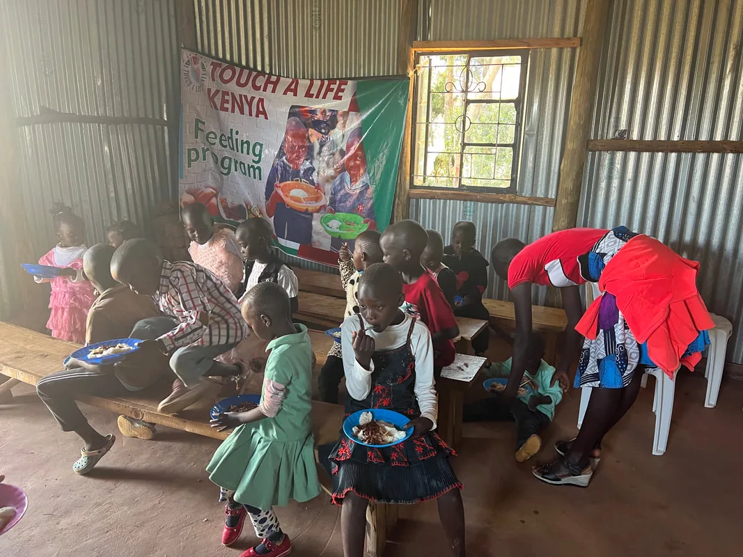 People sharing a meal inside a corrugated-metal building