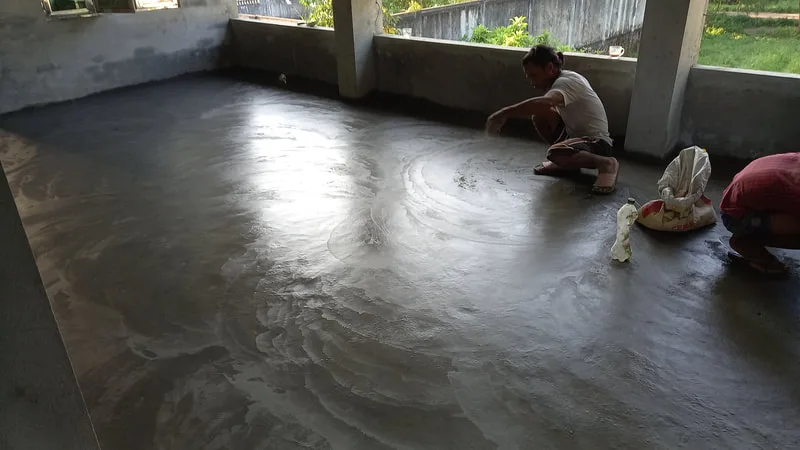 Workers finishing a concrete floor